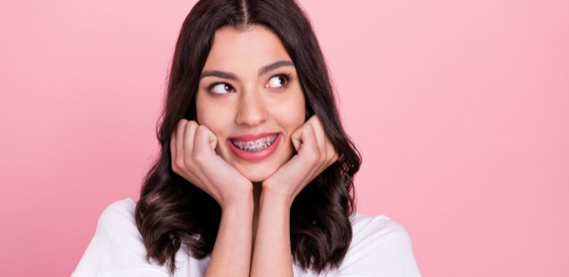 Smiling patient wearing Iconix champagne gold braces