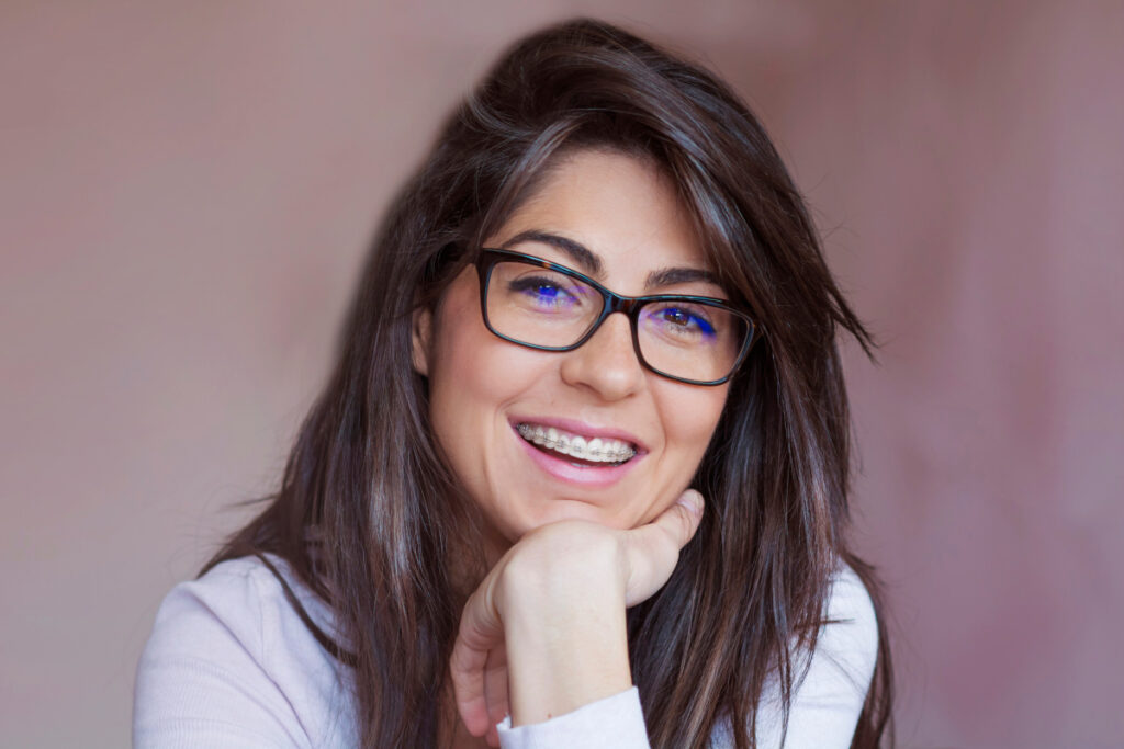 Adult woman with braces smiling